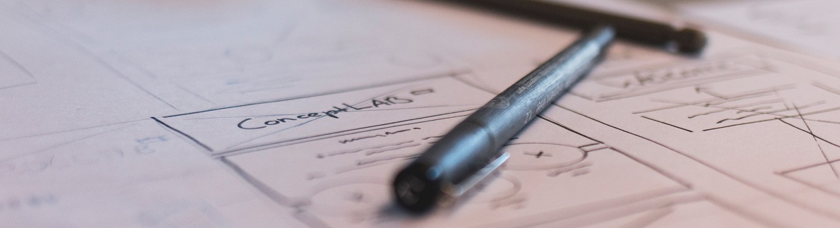 pen atop a page that contains a wireframe